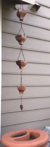 Harvest rainwater using rain chains to direct water from eaves