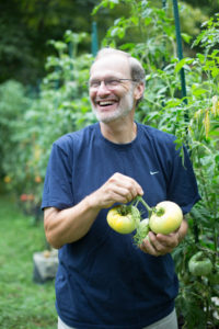 Craig LeHoullier holding epic tomatoes