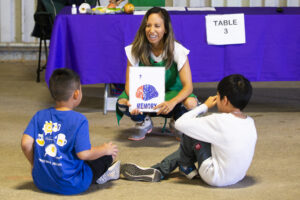 Kim Leon teaching two children about nutrition
