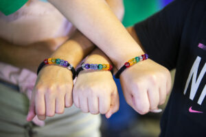 Colorful beads representing food groups on children's wrists