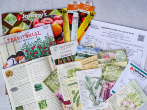 seed packets and catalogs with information to help you choose the vegetable variety best for your garden